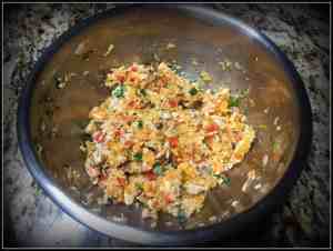 salmon, basil, scallions, sautéed veggies, and mashed sweet potato in a large stainless steel bowl